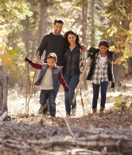 family walking in the woods